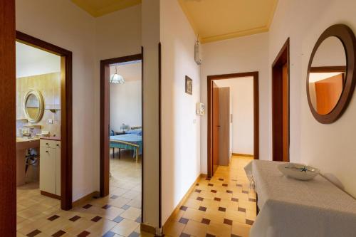a room with a bedroom with a bathroom and a mirror at Villa Rosa di Mare by BararHouse in Torre Lapillo