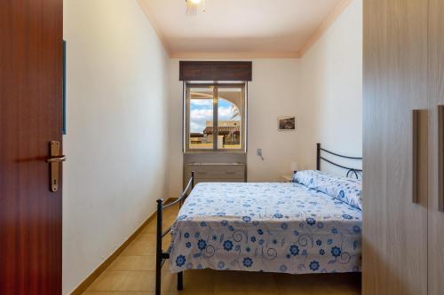 a small bedroom with a bed and a window at Villa Rosa di Mare by BararHouse in Torre Lapillo