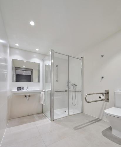a bathroom with a shower and a toilet and a sink at Hostal Lami in Esplugues de Llobregat