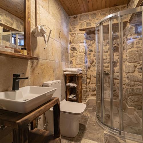a bathroom with a toilet and a sink and a shower at Konak Avula Boutique Hotel in Hatay