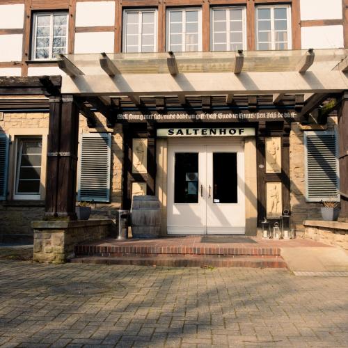 an entrance to a building with a white door at Hotel Saltenhof in Hörstel