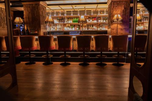 a row of chairs in a bar at BLESS Hotel Madrid - The Leading Hotels of the World in Madrid