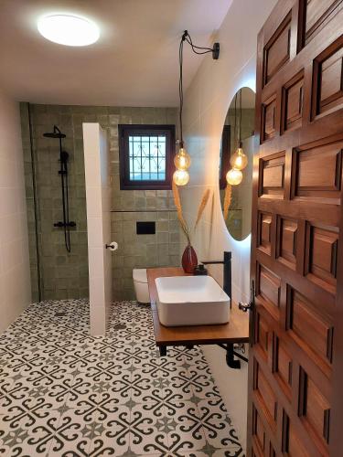 a bathroom with a tub and a sink and a shower at Casa Loko in Coín