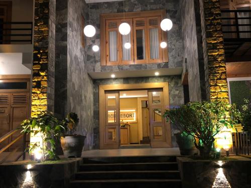 a front door of a building with potted plants at 3 Arch Resort Ella in Ella
