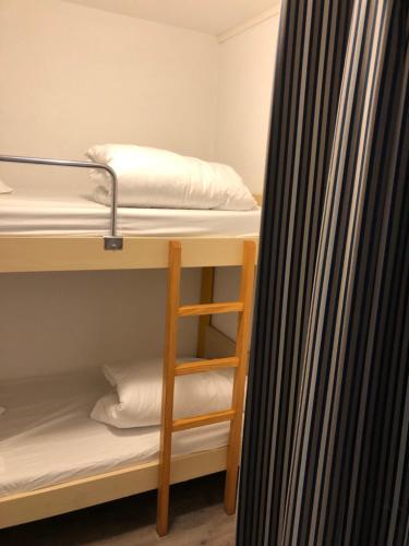 a room with two bunk beds and a curtain at Hippotel in Le Touquet-Paris-Plage