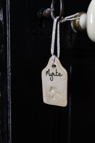 a key chain with the word music on it at MAISON HULOTTE in Amboise
