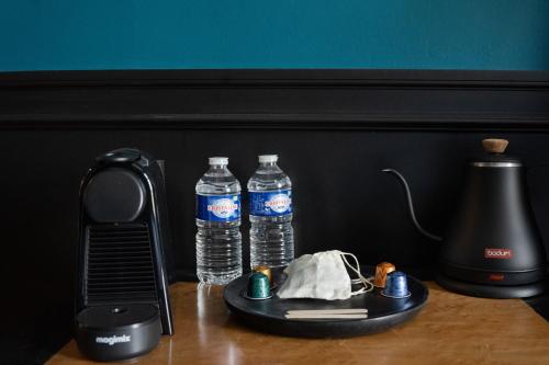 two bottles of water on a table with a blender at MAISON HULOTTE in Amboise