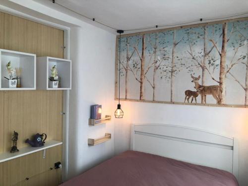 a bedroom with a bed with a painting on the wall at La casita de mi abuela in Santo Domingo de la Calzada