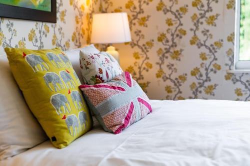 a bedroom with a bed with two pillows on it at Private Parking, Garden, En-suite, 5 Rooms in Llanelli