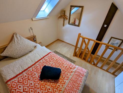 a bedroom with a bed with a pillow and a mirror at Apartment Nada in Kassel
