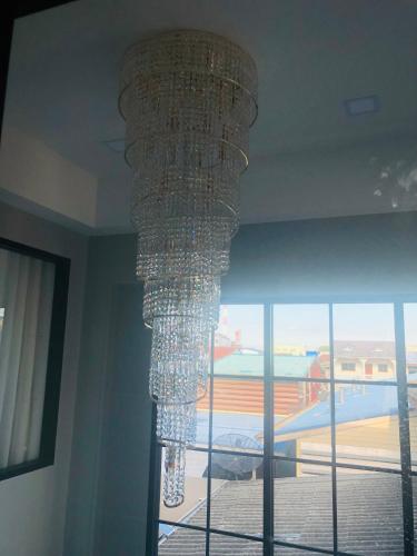 a chandelier hanging from the ceiling in a room at 243Hotel in Ta Phraya