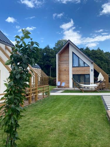 a house with a yard with a boat at Vacanza Park in Łeba