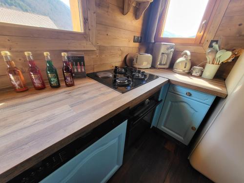 a kitchen with a wooden counter top with a stove at L'Entre 2 Cols in Saint-Martin-sur-le-Chambre