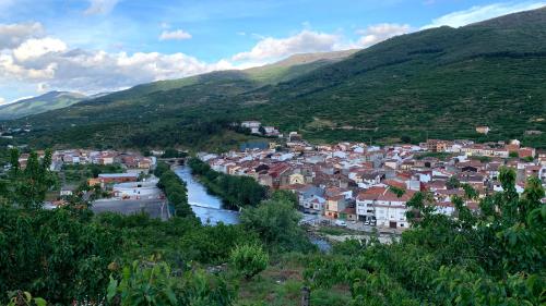 a town in a valley with a river and mountains at LA PARRA - Casa Rural en el Valle del Jerte in Navaconcejo