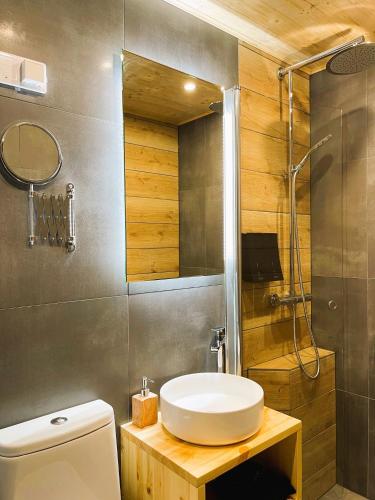 a bathroom with a sink and a shower and a toilet at Beach Hotel Santalahti in Kotka