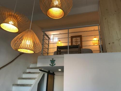 two lights hanging over a staircase with a room at L'Estrambord de Camargue in Saintes-Maries-de-la-Mer
