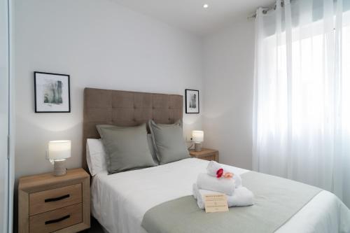 マラガにあるAAC Málaga - Apartamento muy cómodo y bien comunicado, a 1,3km del centroのベッドルーム(ベッド1台、動物の詰め物付)