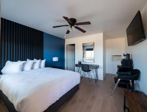 a bedroom with a bed and a ceiling fan at Balanced Rock Inn in Fruita