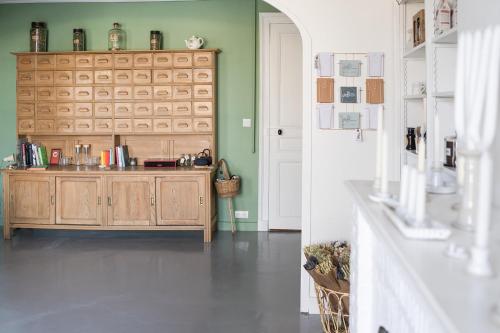 a kitchen with a wooden cabinet in a room at MAISON HULOTTE in Amboise