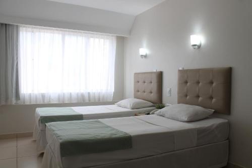 Säng eller sängar i ett rum på Hotel Doral Apucarana