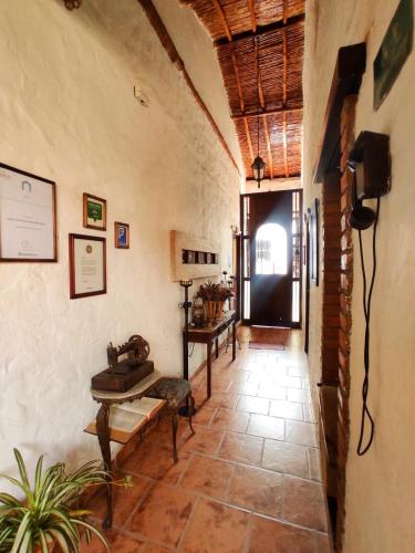 a hallway with a room with a table and a door at Giron Chill Out Hotel Boutique in Girón