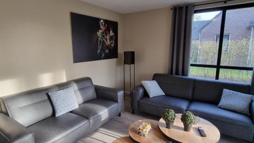 - un salon avec deux canapés et une table dans l'établissement Vakantiewoning Maas en Waal 100, à Ewijk