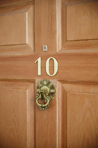 a wooden door with the number on it at Stylish Private Flat Near St. Andrews Golf Course in Cupar