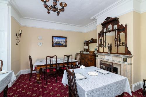 a dining room with a table and a fireplace at Riverdale House B&B in Athlone