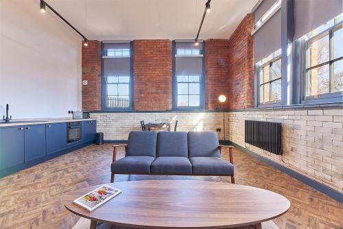 a living room with a couch and a table at No 3 at Simpson Street Apartments Sunderland in Sunderland