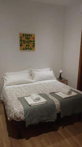 a bedroom with a bed with two towels on it at Amalia Suites - Via San Zanobi in Florence