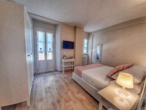 - une chambre avec un lit et une table avec une lampe dans l'établissement Alessia Home, à Cannobio