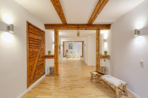 a hallway with a wooden door and a bench at Harz-Urlaubs-Alm Hotel & Ferienhäuser in Clausthal-Zellerfeld