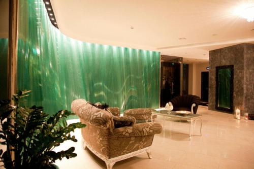 a living room with a large aquarium and a chair at Kalavrita Canyon Hotel & Spa in Kalavrita