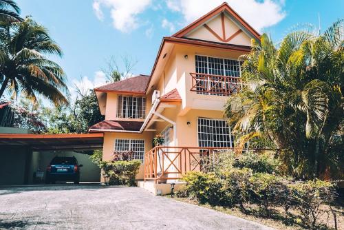 a house with a car parked in front of it at La Jolie - Luxury Ocean View Villa in Black Rock