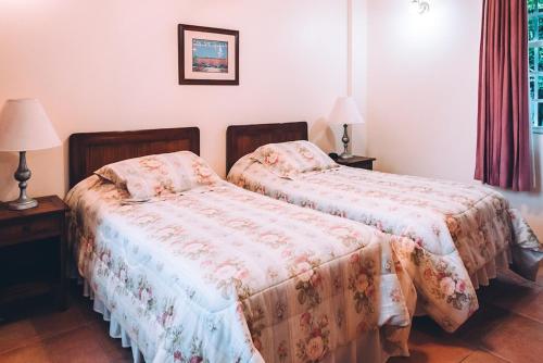 two beds sitting next to each other in a bedroom at La Jolie - Luxury Ocean View Villa in Black Rock