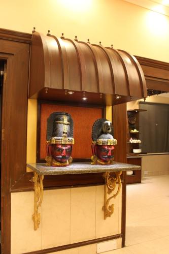 a shelf with two vases on it in a store at Taj Mahal Hotel Abids in Hyderabad