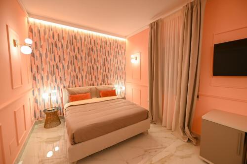 a hotel room with a bed and a tv at Anama B&B in Lucera