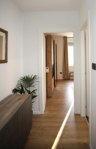 a hallway with white walls and a wooden floor at Apartments INCIS next to the Pula Amphitheather in Pula