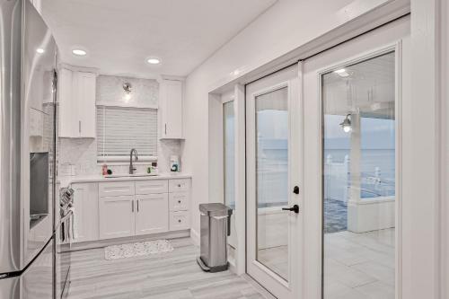 a white kitchen with a view of the ocean at Sunrise Beach Retreat in Flagler Beach