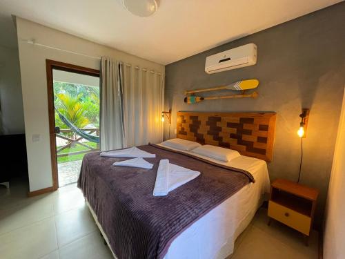 Un dormitorio con una cama grande y una ventana en Pousada Villa Dos Sonhos, en Itacaré