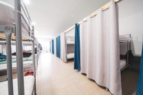 a row of bunk beds in a dorm room at Albergue Barullo - Cubículos - Literas - Habitaciones in Sarria