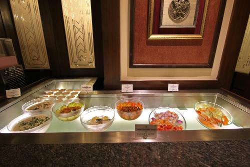 a display case with bowls of different types of food at Taj Mahal Hotel Abids in Hyderabad