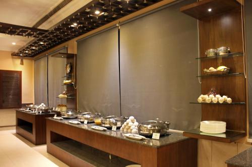 a kitchen with a counter with a bunch of food at Taj Mahal Hotel Abids in Hyderabad