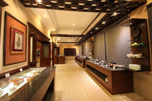 a restaurant with a buffet line with food on display at Taj Mahal Hotel Abids in Hyderabad