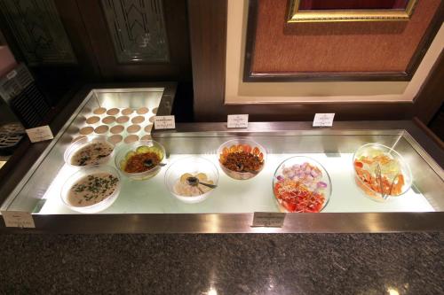 a display case filled with different types of food at Taj Mahal Hotel Abids in Hyderabad