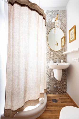 a bathroom with a shower curtain and a sink at Casa Doña Carmela GuestHouse - Tenerife in Santa Cruz de Tenerife