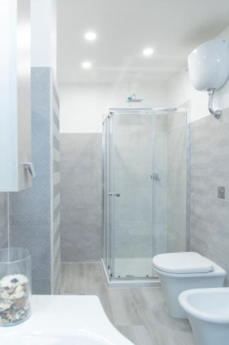 a bathroom with a shower and a toilet and a sink at Albergo Libera Gioventù in Torre Annunziata