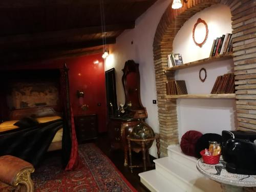 a bedroom with a bed and a red wall at La stanza nel parco in Anguillara Sabazia