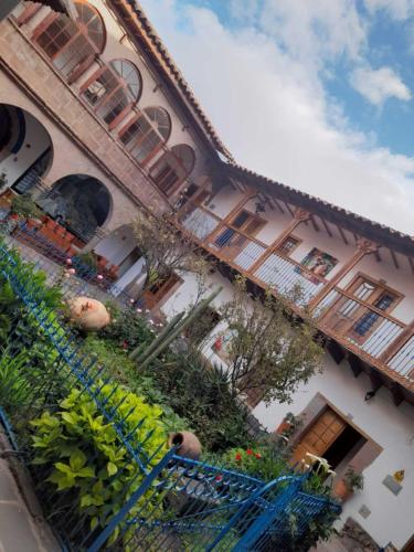 a building with a bunch of plants on the side of it at Terra Sagrada Cusco in Cusco