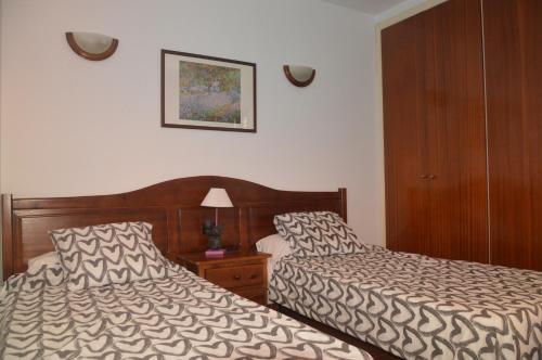 Habitación de hotel con 2 camas junto a una mesita de noche en Holiday House Always Sun, en Playa de Santiago
